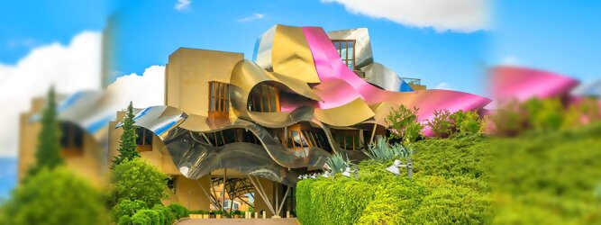 Trip Oberösterreich Reisetipps - Marqués de Riscal Design Hotel, Bilbao, Elciego, Spanien. Fantastisch galaktisch, unverkennbar ein Werk von Frank O. Gehry. Inmitten idyllischer Weinberge in der Rioja Region des Baskenlandes, bezaubert das schimmernde Bauobjekt mit einer Struktur bunter, edel glänzender verflochtener Metallbänder. Glanz im Baskenland - Es muss etwas ganz Besonderes sein. Emotional, zukunftsweisend, einzigartig. Denn in dieser Region, etwa 133 km südlich von Bilbao, sind Weingüter normalerweise nicht für die Öffentlichkeit zugänglich.
